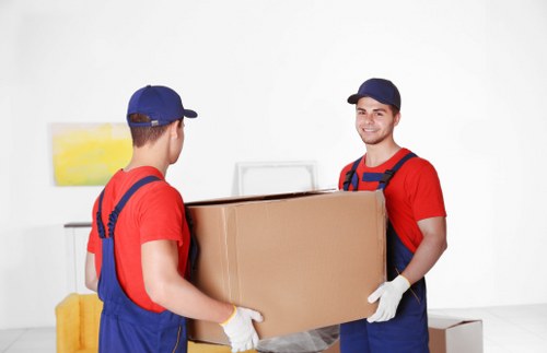 House removalists in Greenwich handling furniture in a narrow staircase