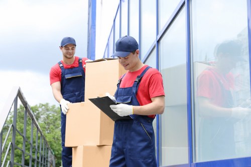Professional movers carrying furniture during a Greenwich relocation