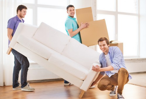 Professional removals team loading boxes and furniture for a flat move in Greenwich