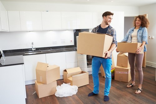 Professional moving team loading boxes into a van in Greenwich