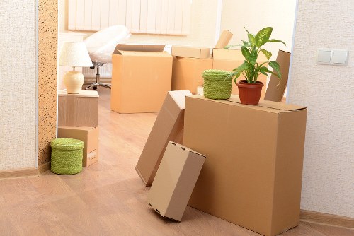 Organized moving boxes labeled for rooms during Greenwich relocation services